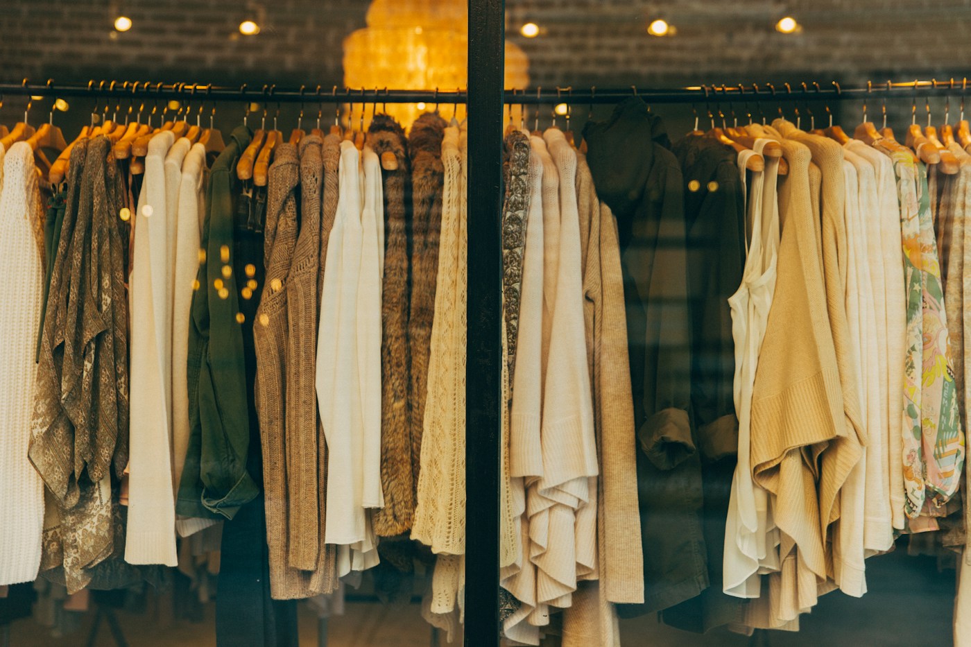 A rail of familiar knitwear and jackets in warm neutral tones